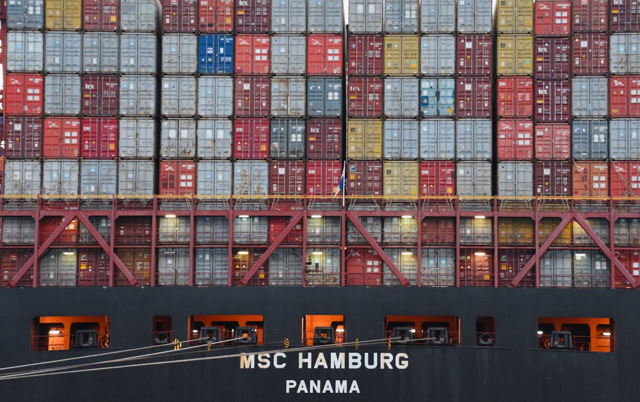 our-story-01 Stacked shipping containers aboard MSC Hamburg at the bustling port of Hamburg.